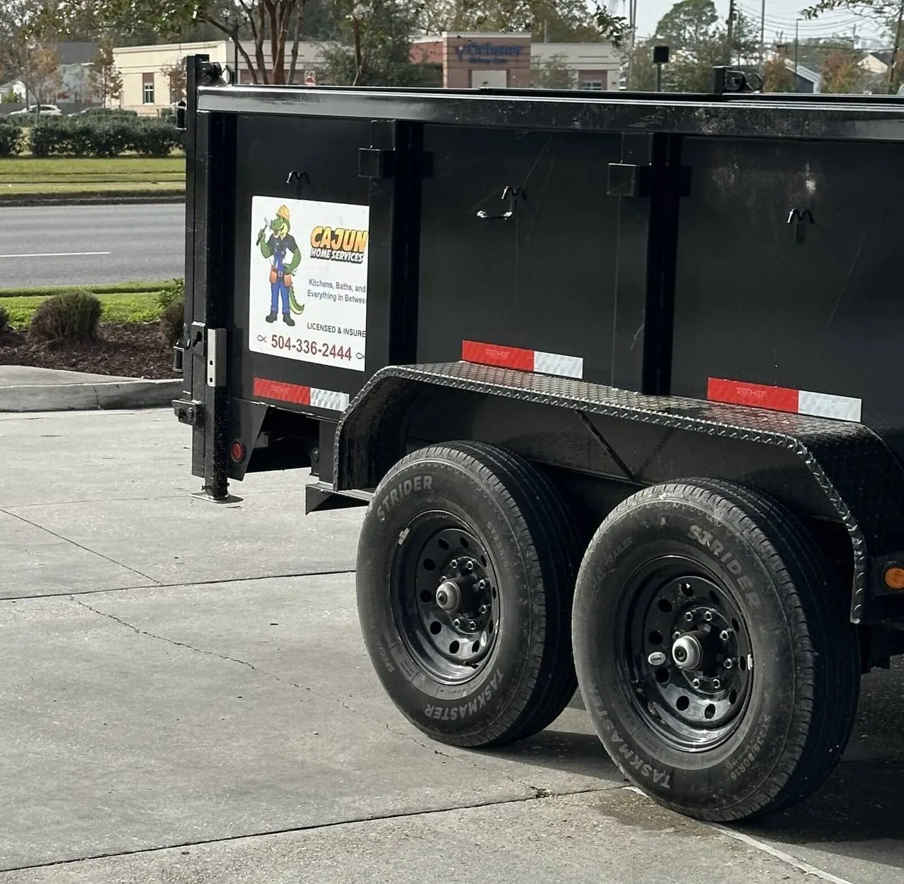 Cajun Home Services branded dump trailer on jobsite - Metairie, LA