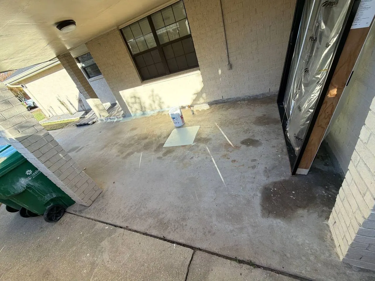Carport concrete coating in progress at Metairie residential property