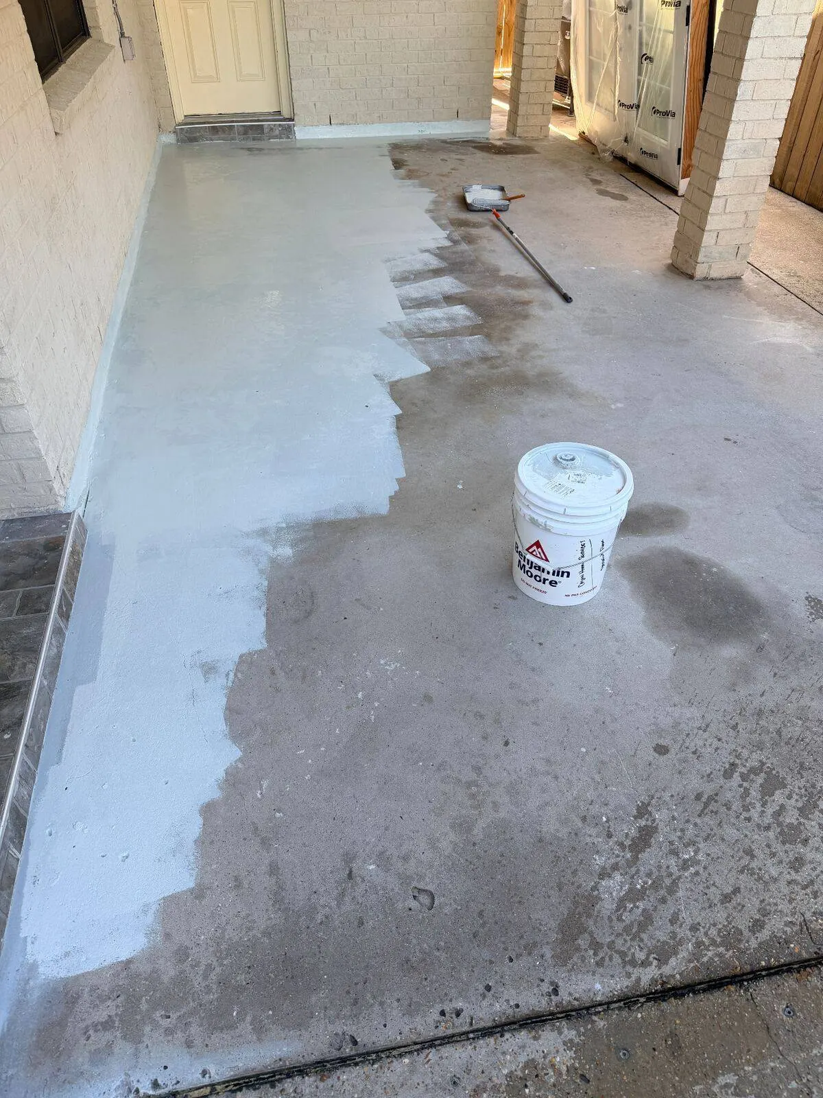 Concrete patio coating application in progress at Metairie home