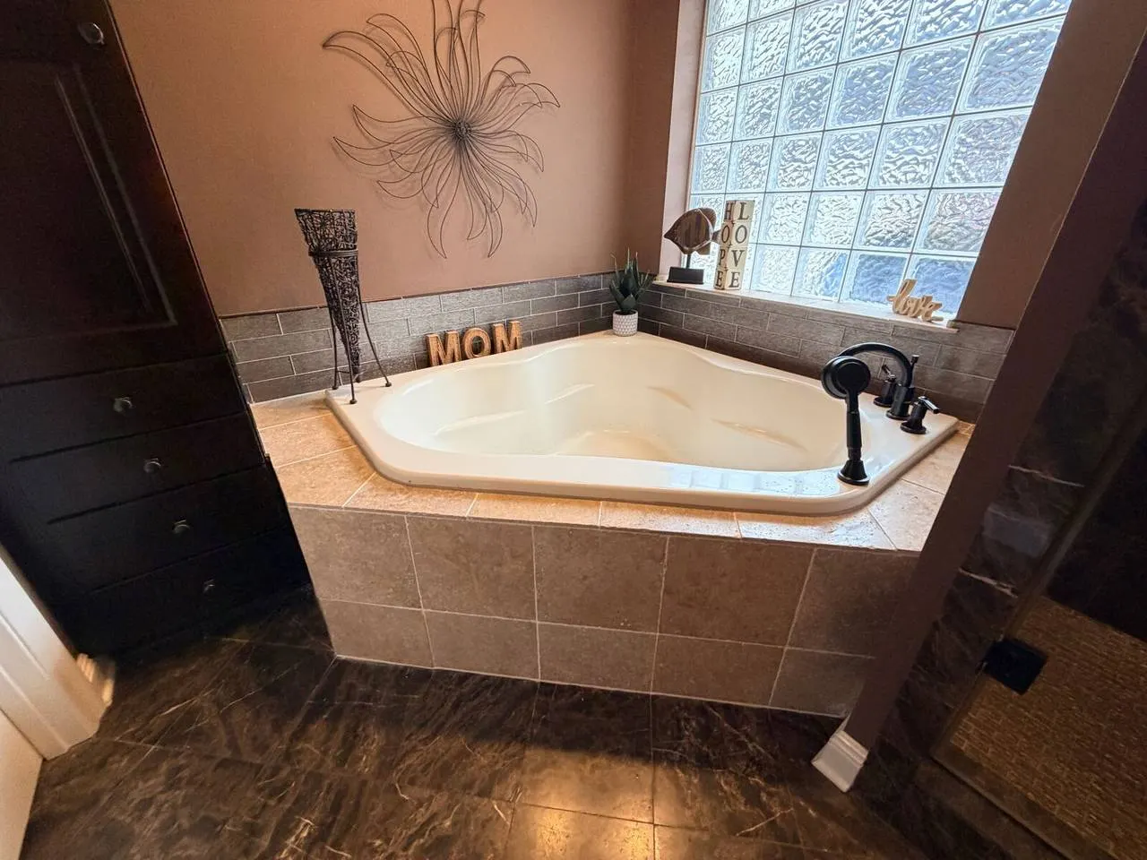 Corner tub with custom tile surround in Destrehan bathroom remodel