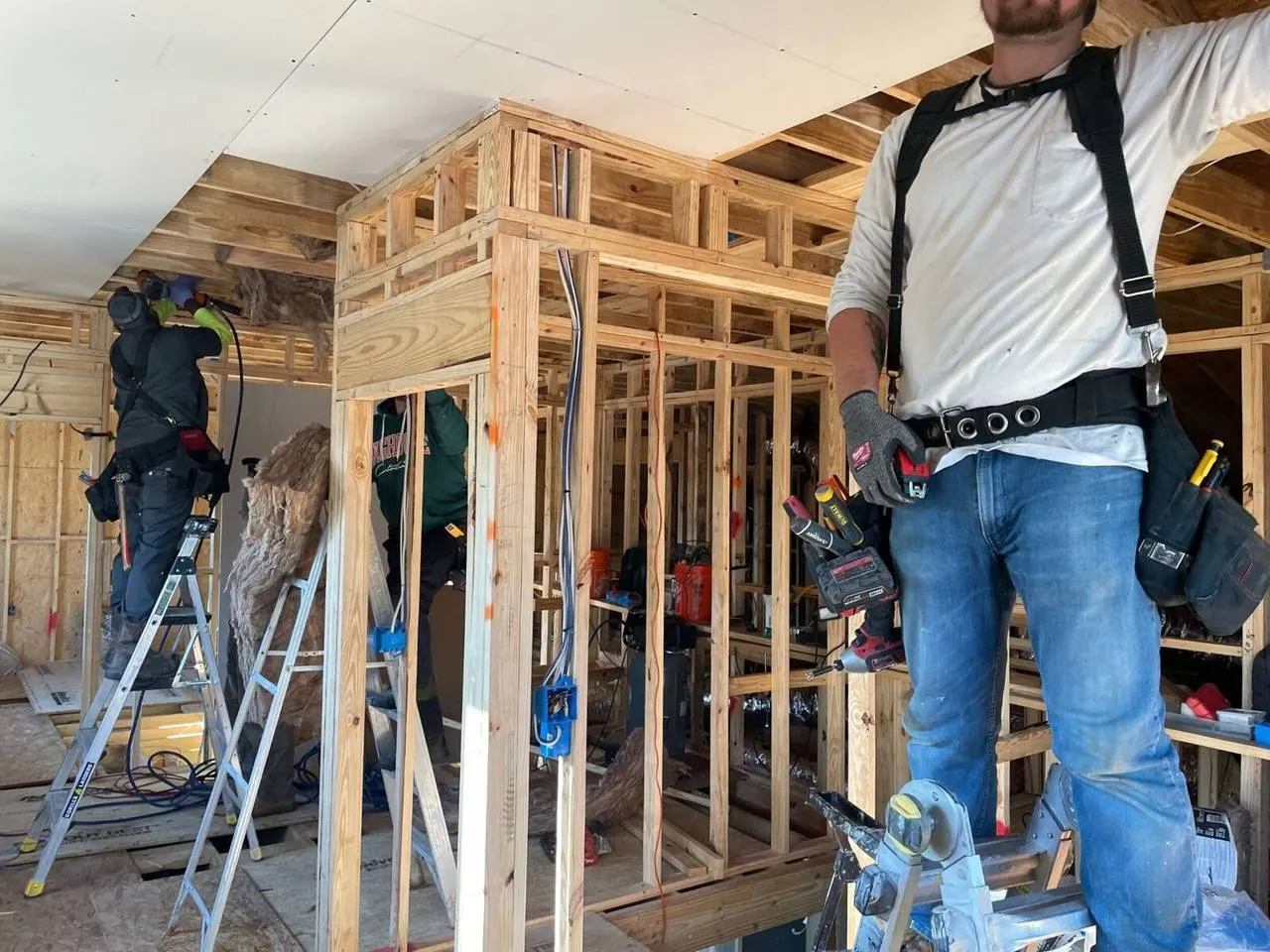 Construction crew framing interior walls during home addition in Harvey Louisiana