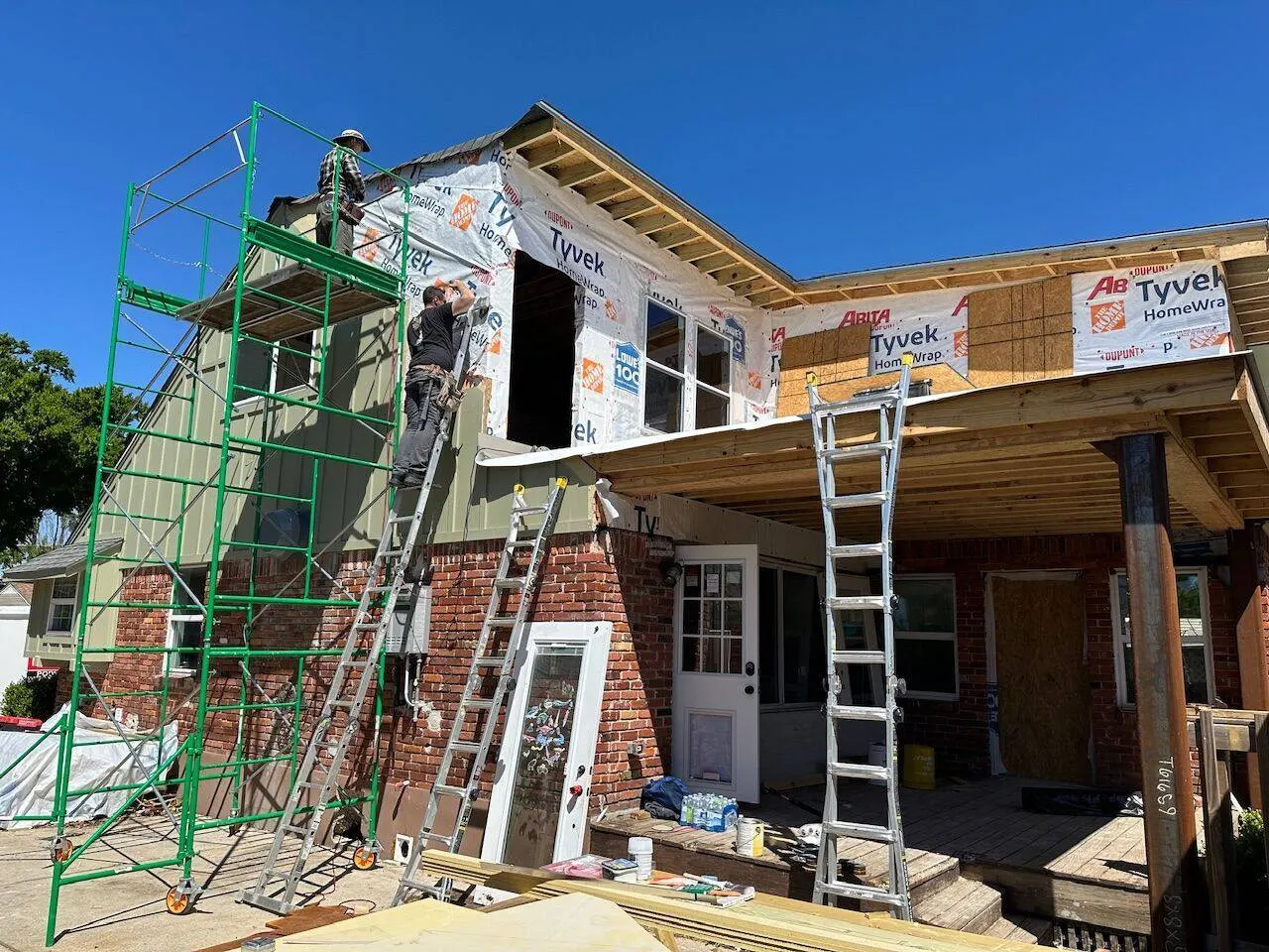 Scaffolding setup for siding installation on two-story Louisiana home