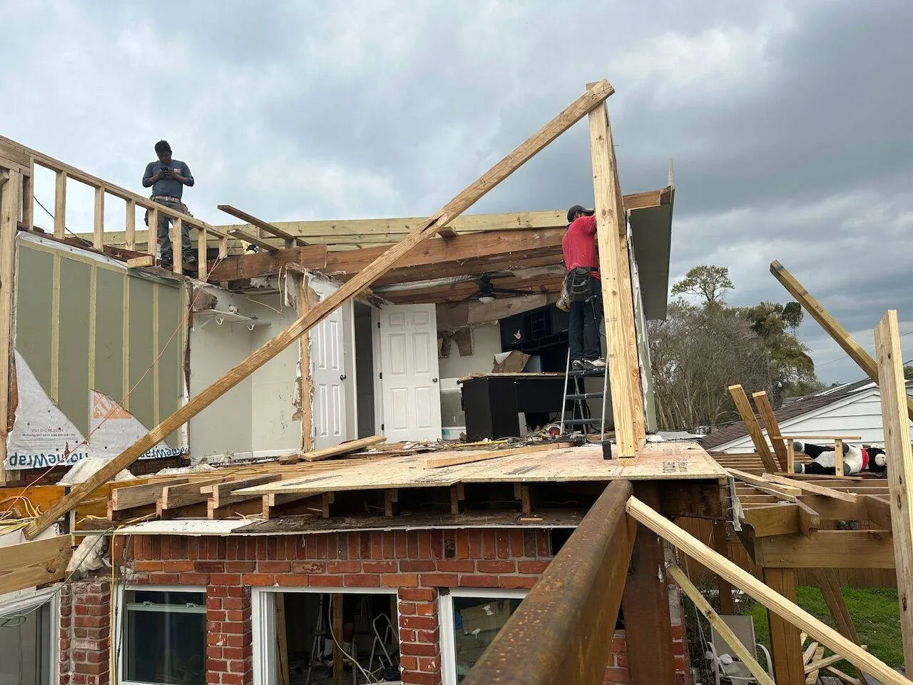 Crew framing second story addition on brick home in New Orleans