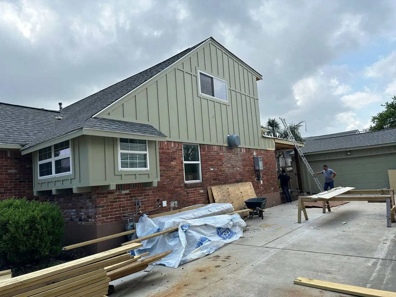 Crew installing HD architectural shingles on residential roof