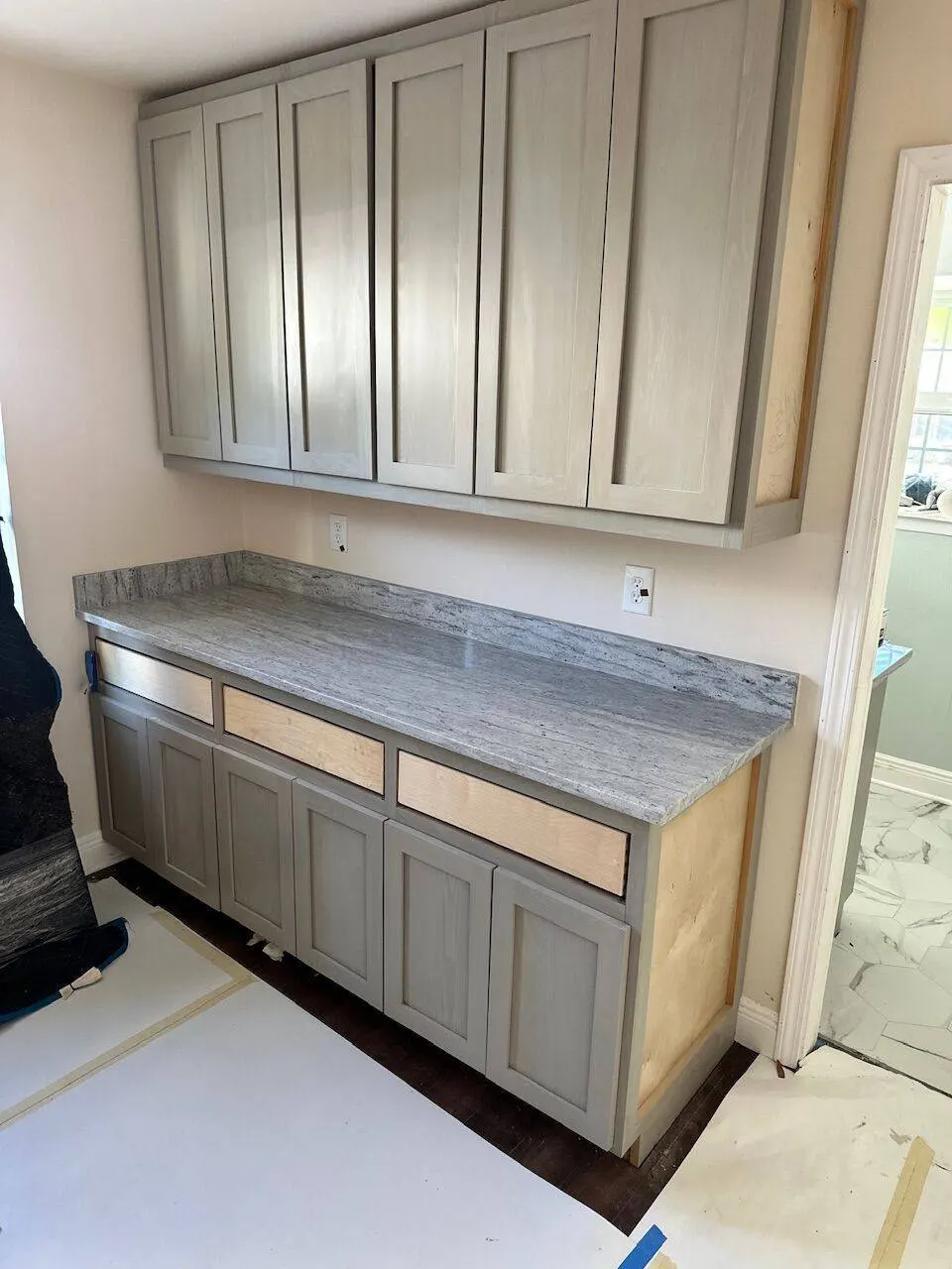 Custom gray cabinetry with granite countertop installation in Jefferson Parish kitchen remodel