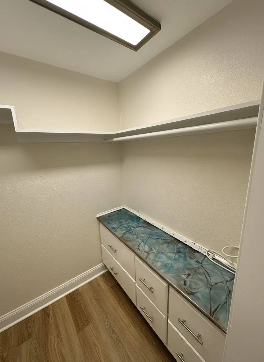 Custom walk-in closet build with epoxy countertop and storage drawers in Metairie LA