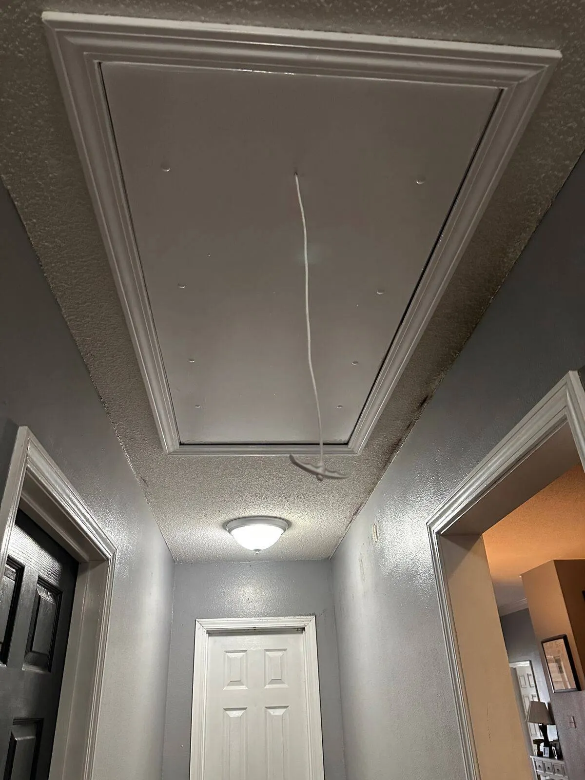 Completed attic ladder installation with finished trim in Destrehan, St. Charles Parish