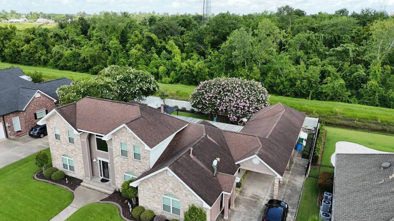 Aerial view of completed shingle roof on two-story home in Destrehan, Louisiana