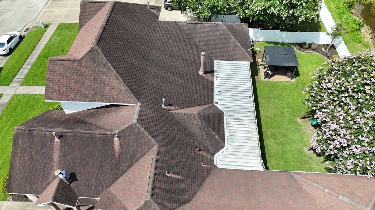 Aerial before photo showing leaky aluminum awning on Destrehan home needing patio replacement