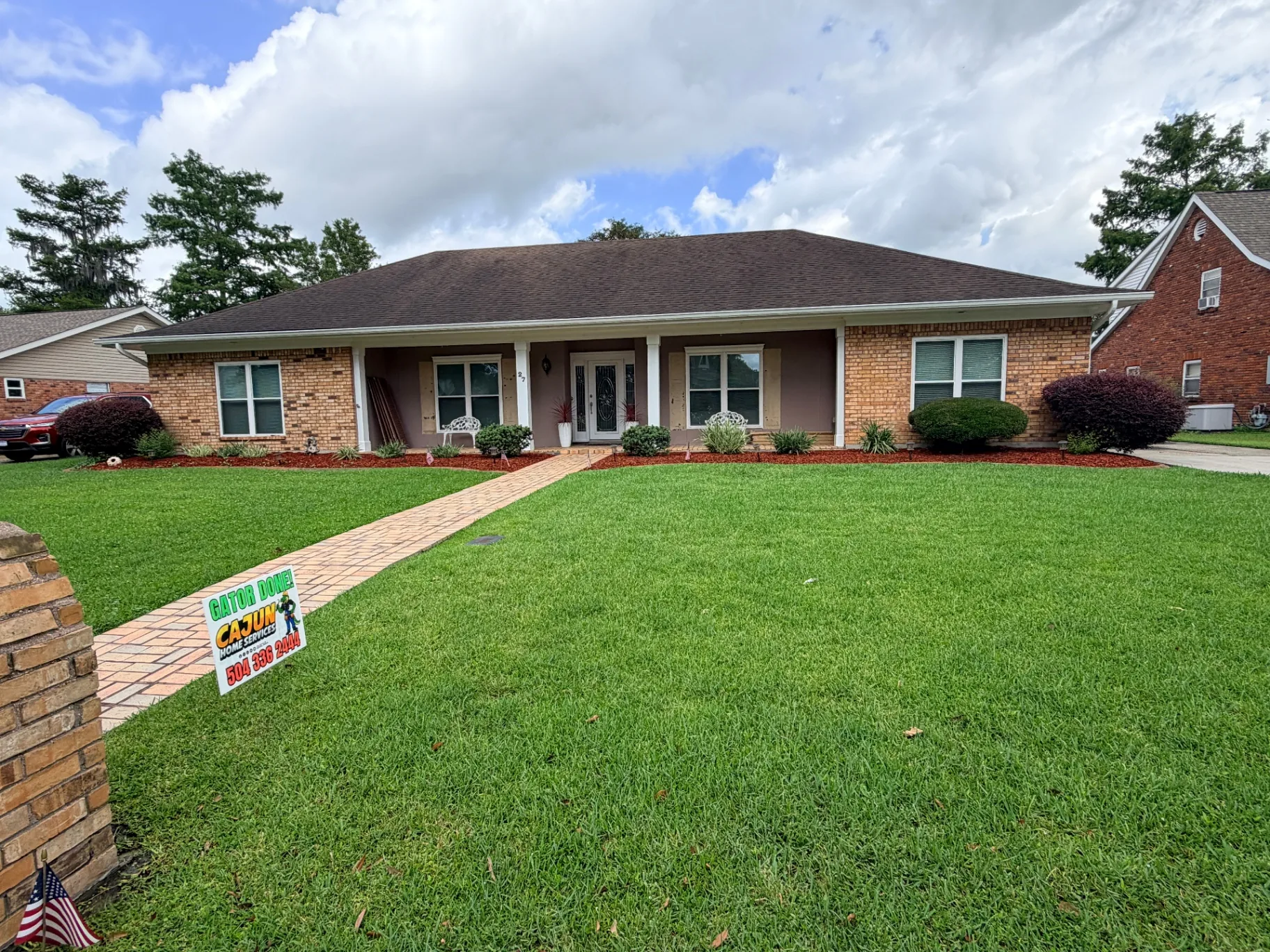 Destrehan brick home with old shutters removed showing bare brick and stucco wall