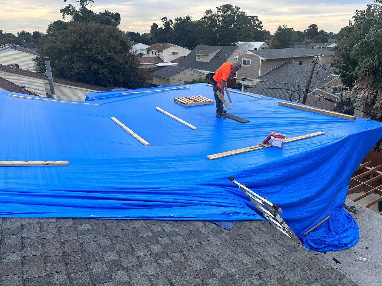Emergency tarp installation by Cajun Home Services to protect roof during storm repairs