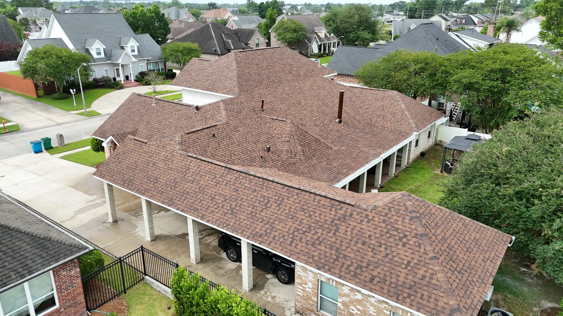 Finished architectural shingle roof on a large Destrehan Louisiana home photographed from a drone after full roof replacement by Cajun Home Services