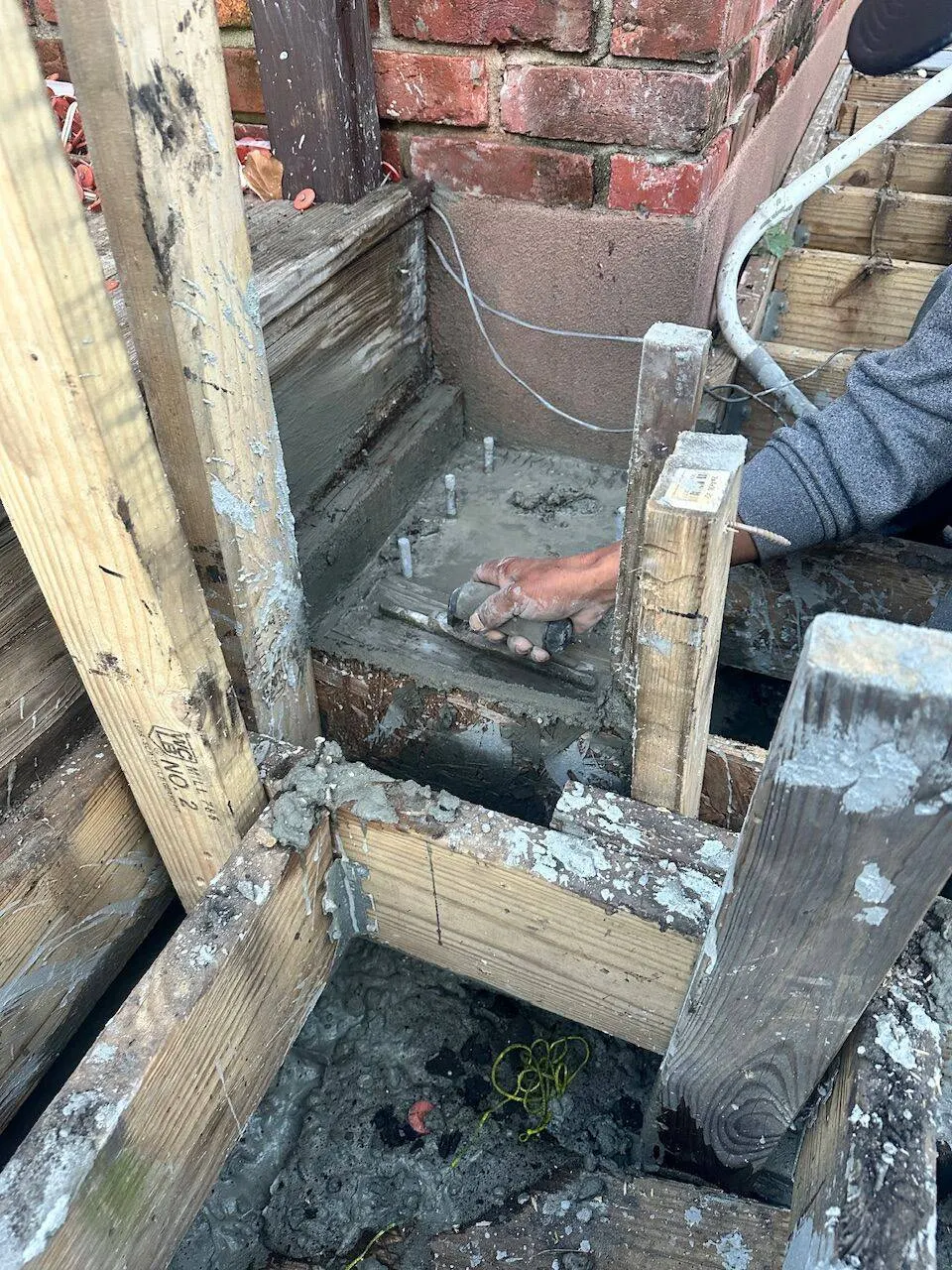 Foundation pier concrete pour with anchor bolts for structural repair in New Orleans