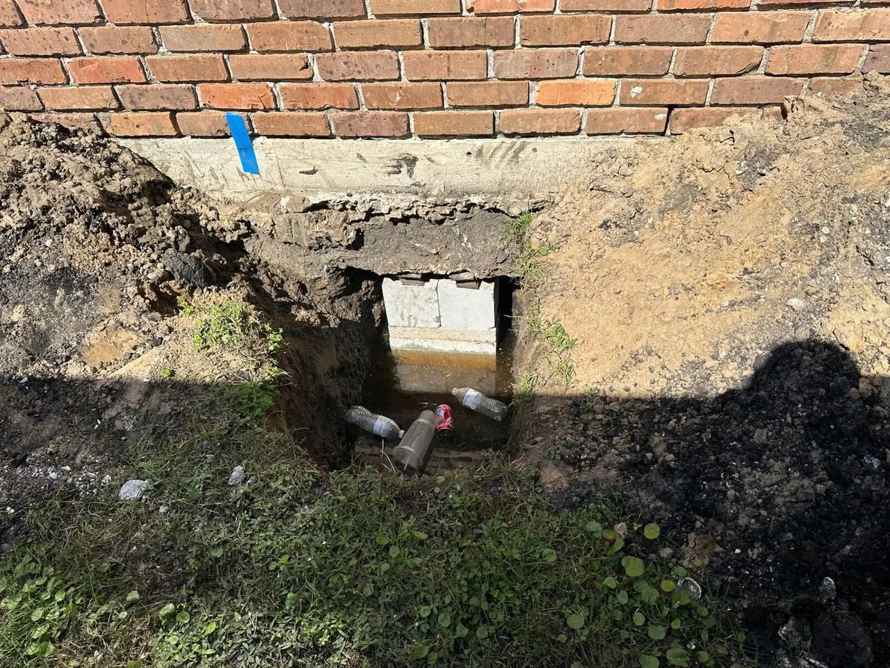 Foundation pier excavation showing concrete footing in Metairie addition project