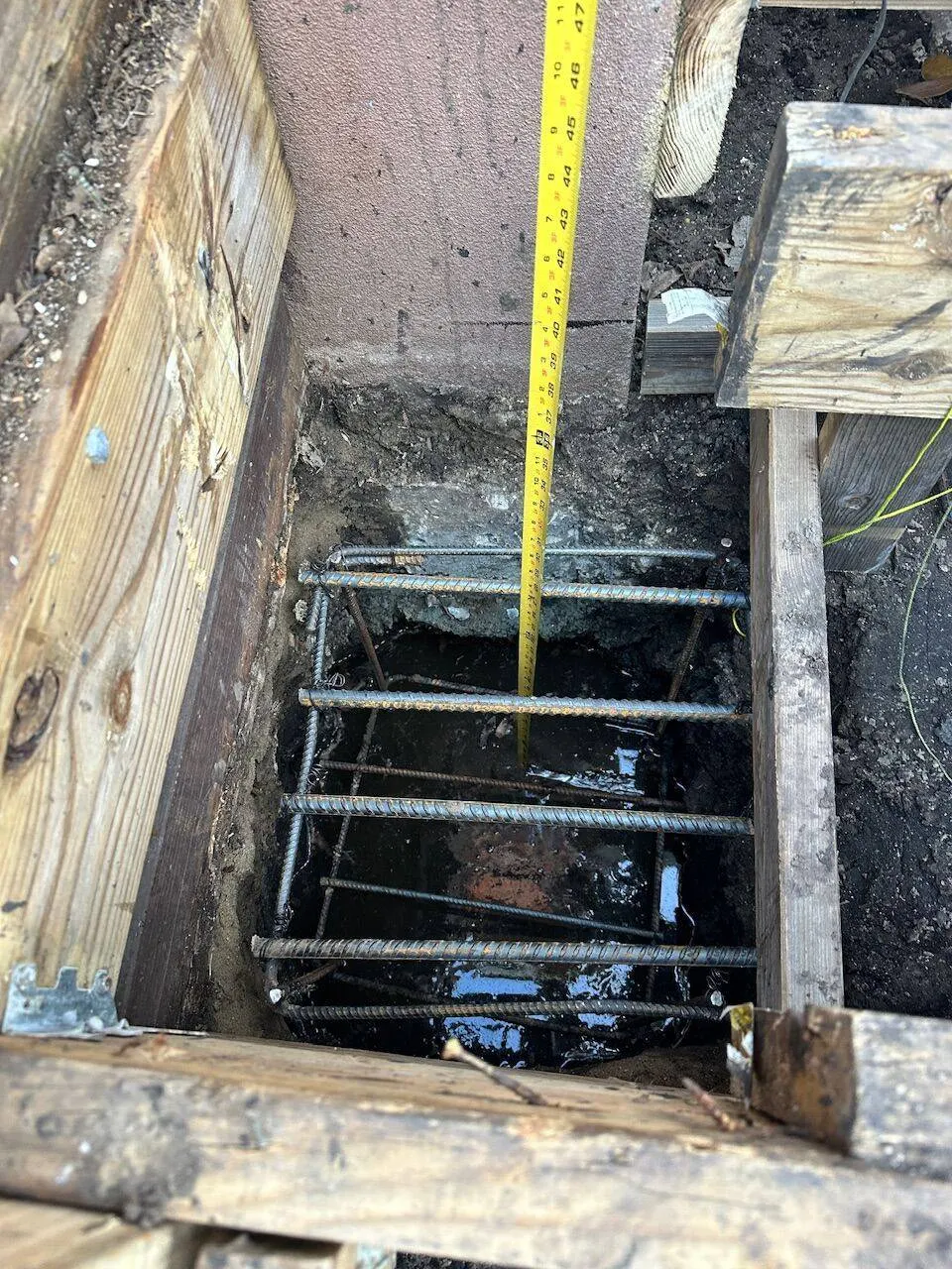 Foundation pier rebar cage at full depth before concrete pour in Jefferson Parish