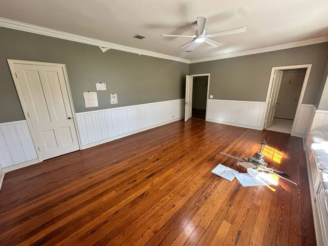 Hardwood floor refinishing in living room with wainscoting in Covington LA