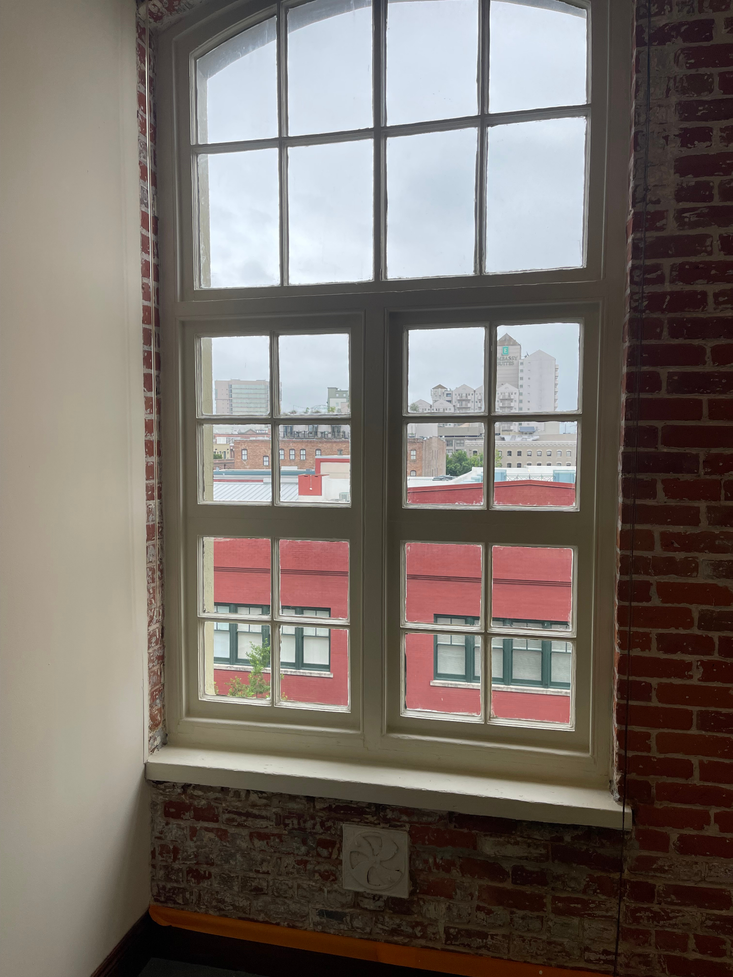 Completed historic wood window restoration in the New Orleans Arts District showing crisp glazing and paint lines