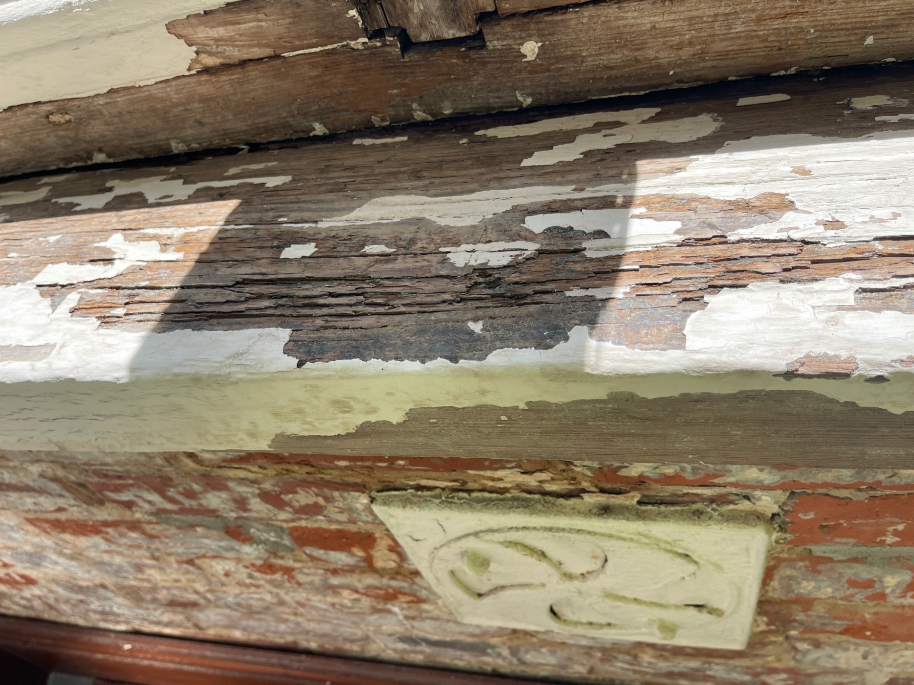 Historic window during preparation stage with finish removal underway in New Orleans