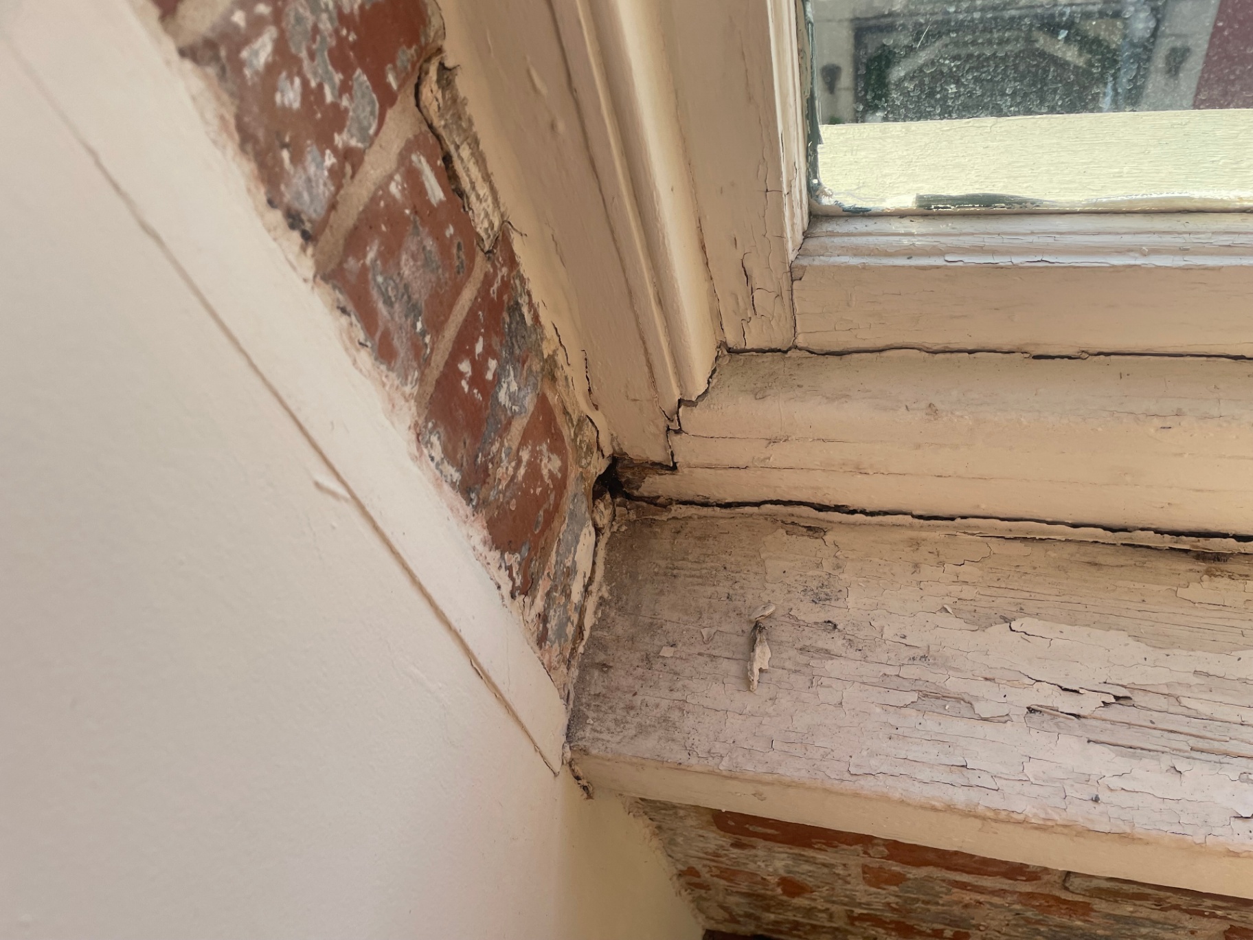 Careful preparation of wood historic window before glazing and paint work