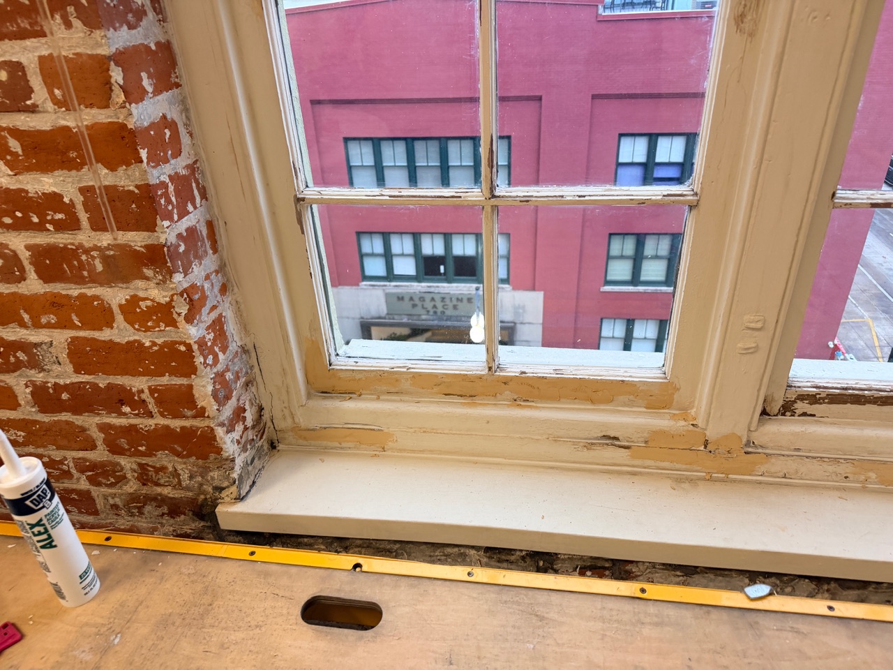 Historic window patching and glazing work in progress on New Orleans restoration project