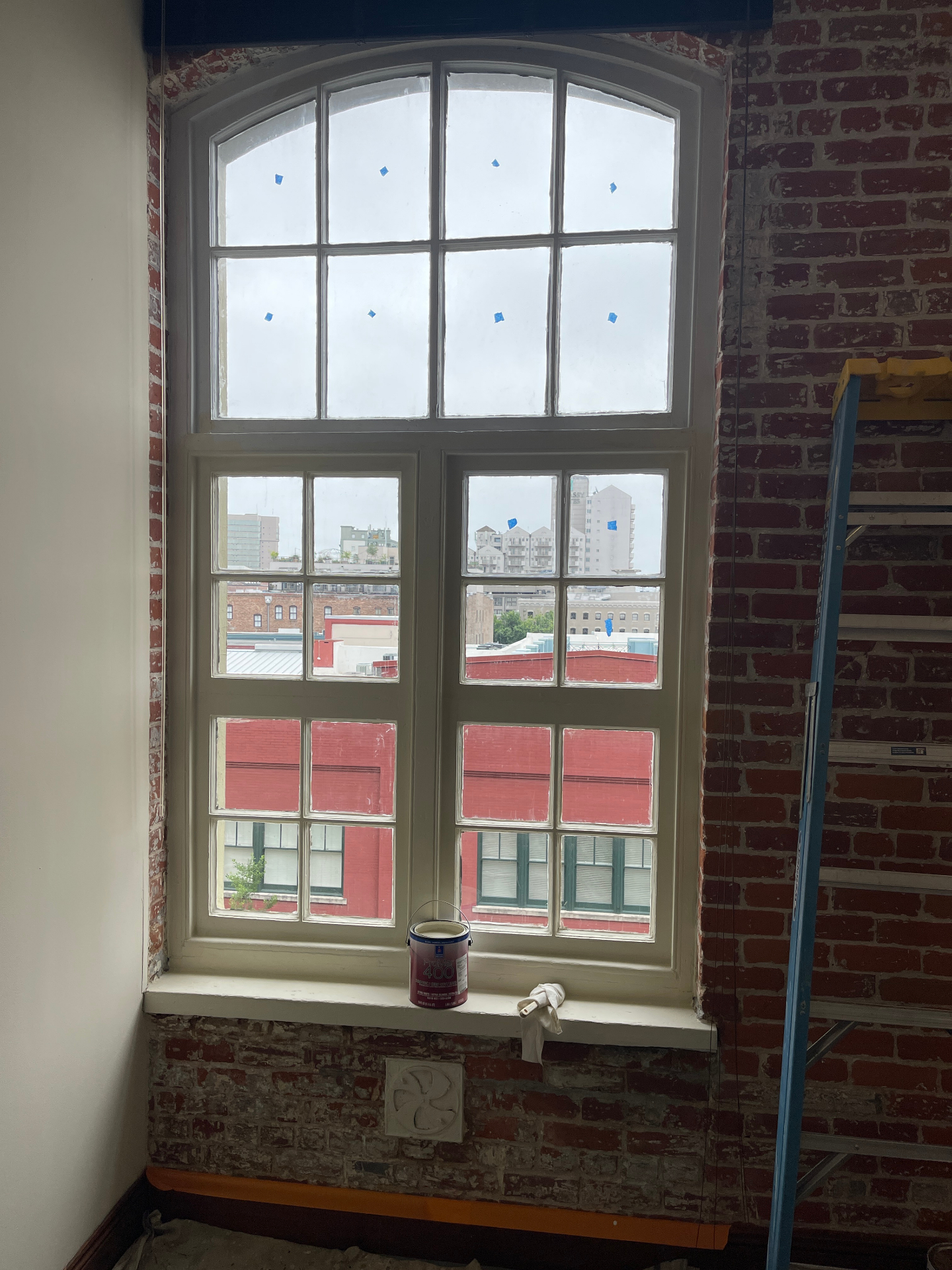 Historic window restoration nearing completion with repaired and painted surfaces