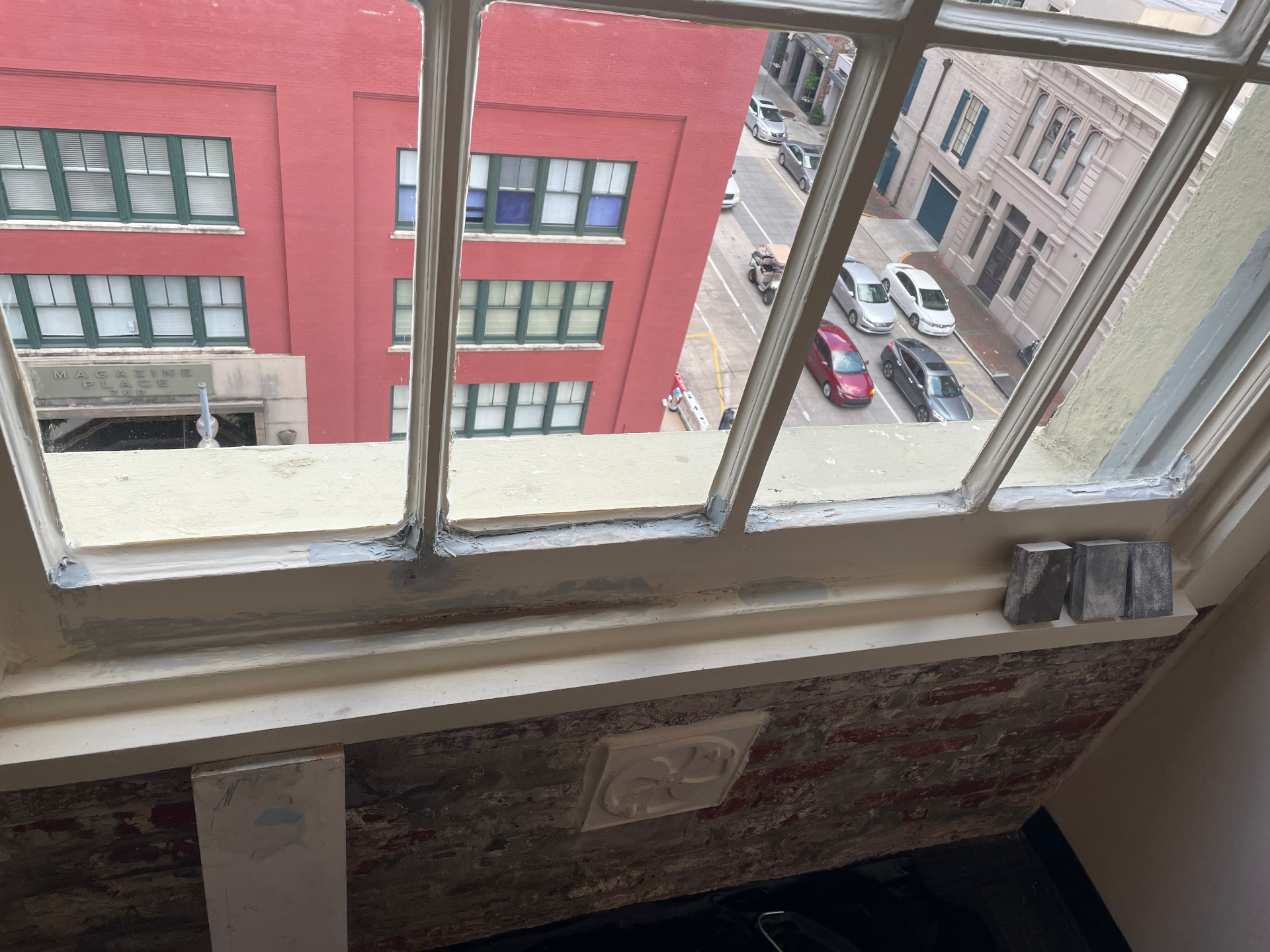 Priming stage of historic window restoration in New Orleans office building