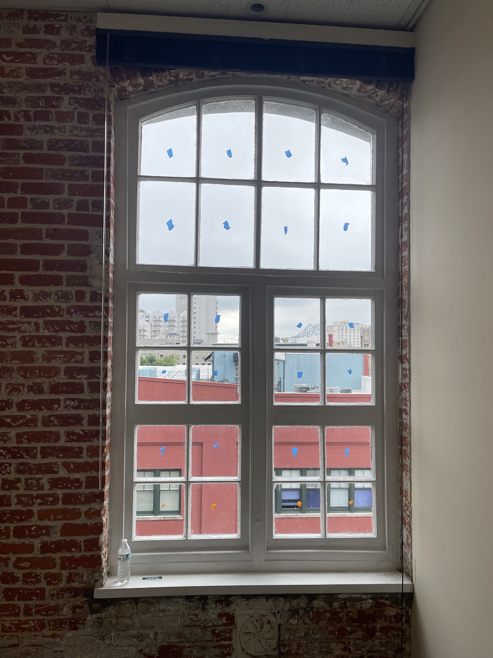 Restoration crew finish work on historic wood window in New Orleans