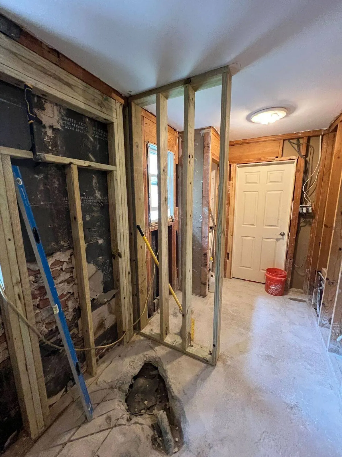 Interior demolition and wall reframing with new studs during whole home renovation in Harvey Louisiana