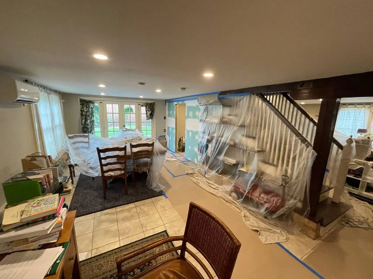 Interior paint preparation with protective plastic sheeting during whole home renovation in Metairie