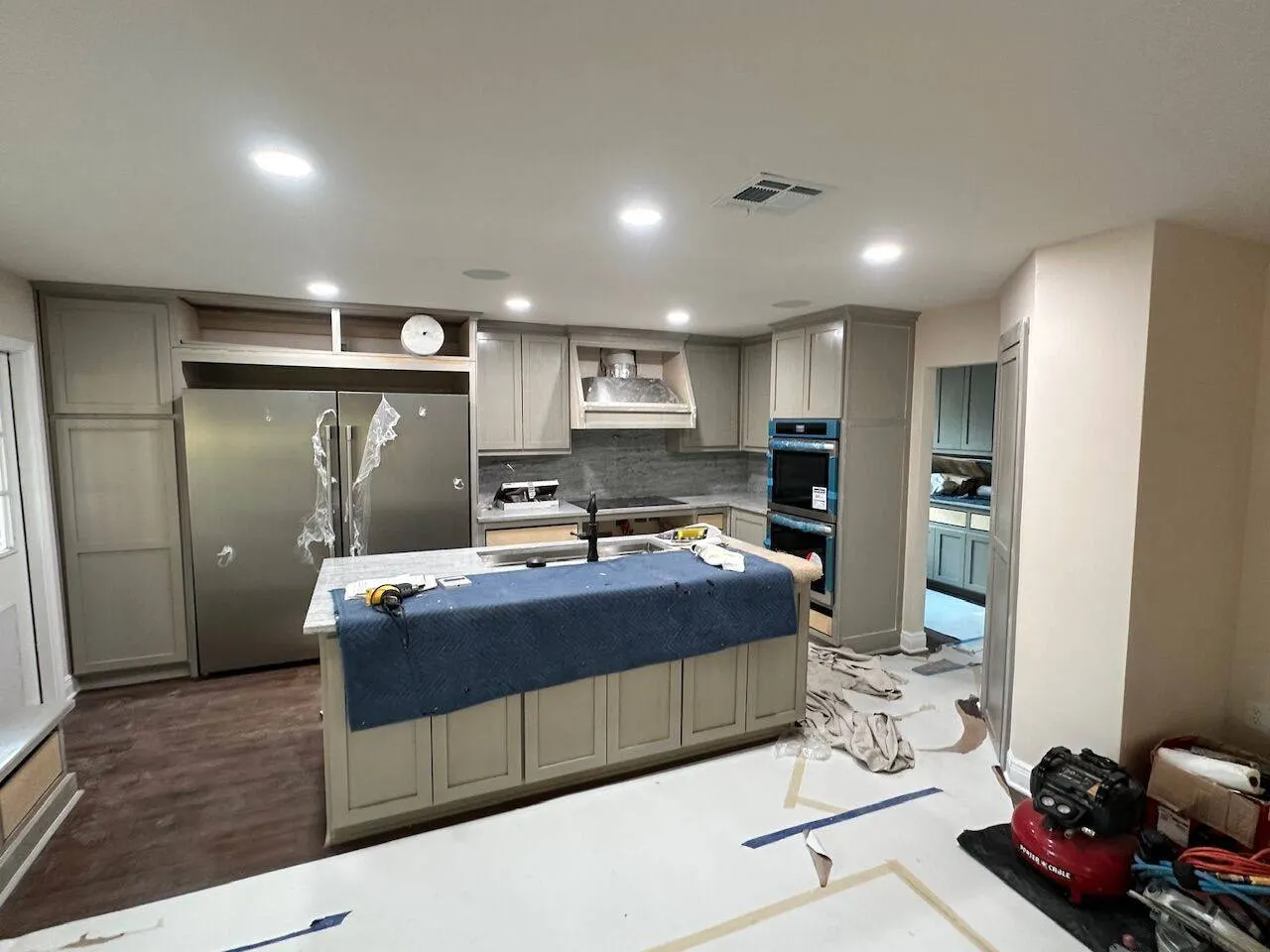 Kitchen remodel in progress with island, granite countertops and stainless appliances in Metairie Louisiana