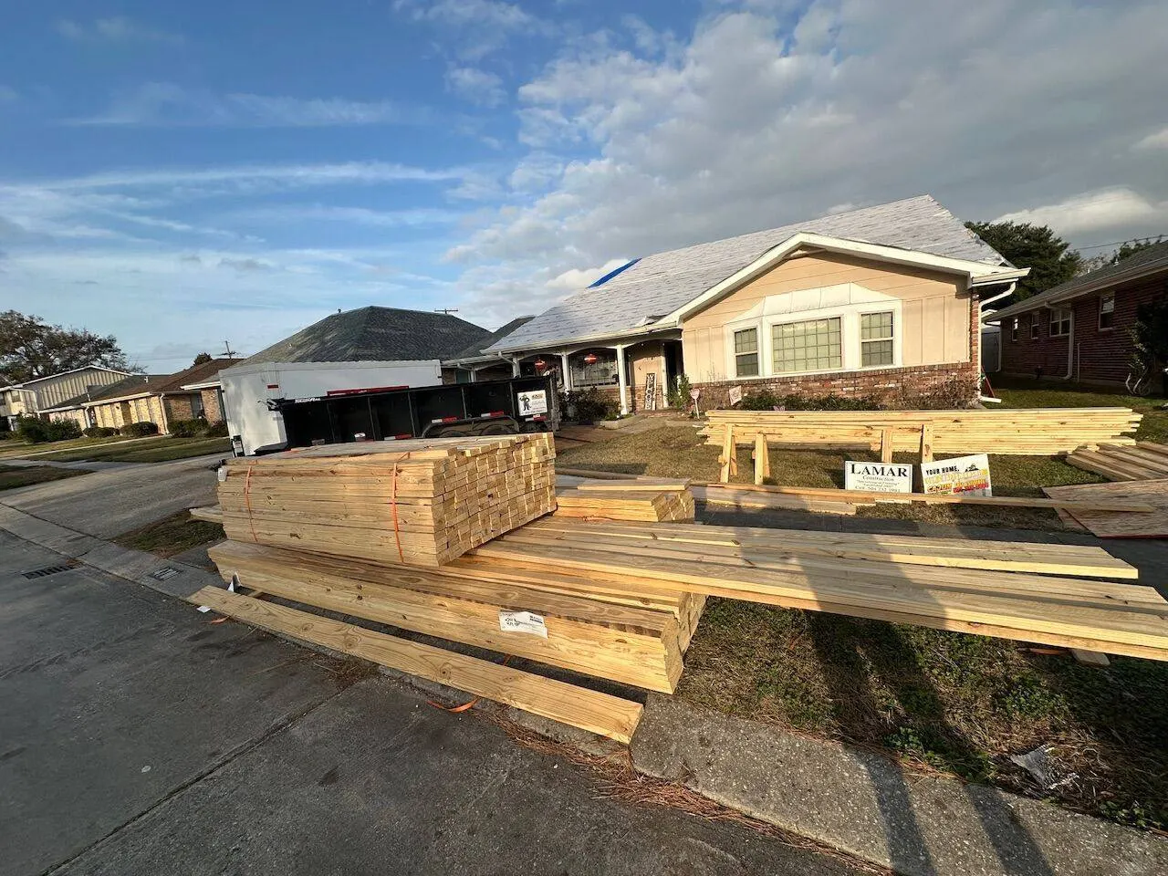 Lumber delivery for second floor addition project with materials staged in Metairie