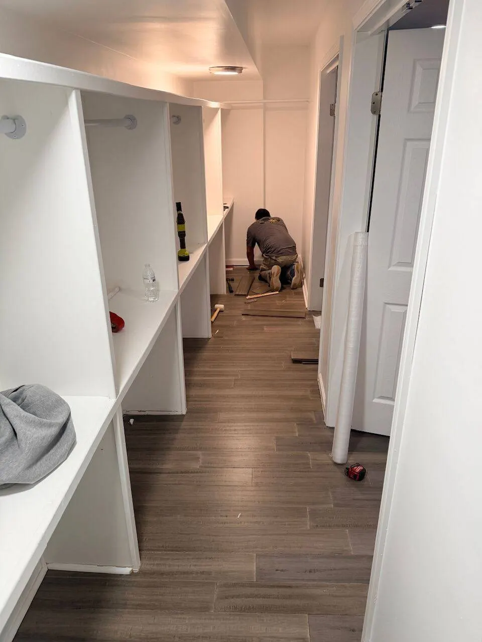 LVP flooring installation in walk-in closet with custom shelving in Metairie LA