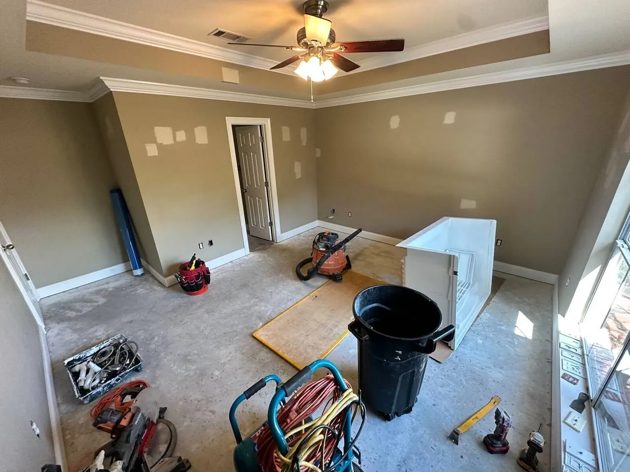 Master bedroom renovation in progress with tools and equipment