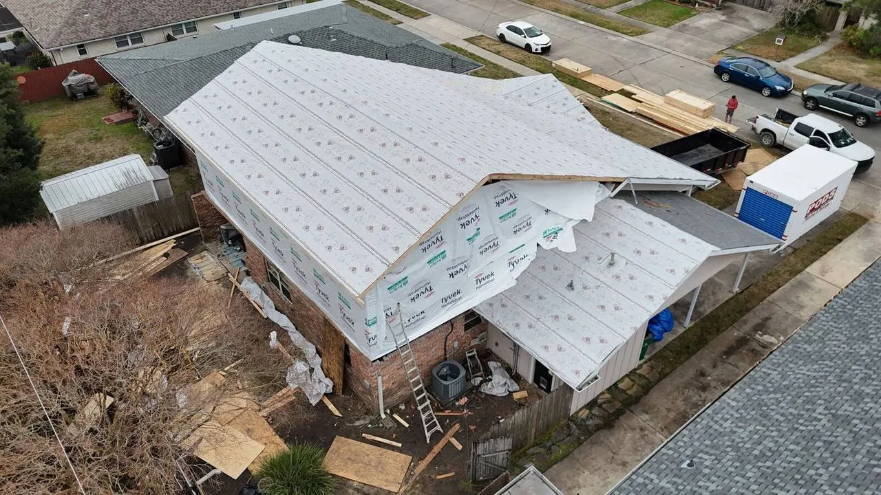 Aerial view of home addition construction with exposed framing in Metairie