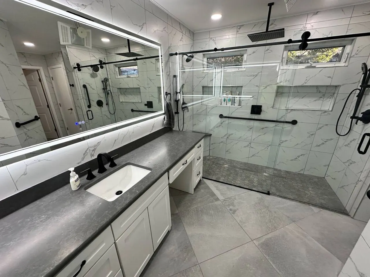 Modern walk-in shower bathroom remodel with glass enclosure and rain shower head in Metairie LA