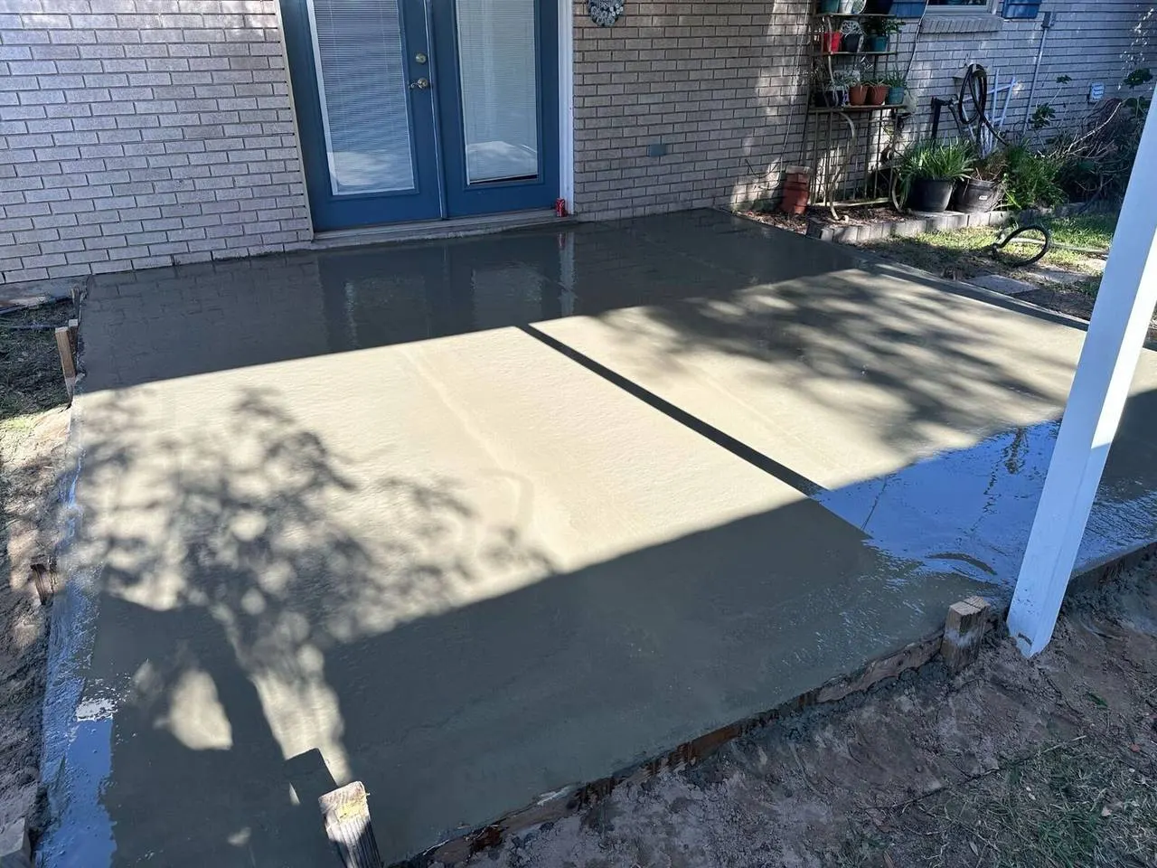 New concrete patio slab installation at Metairie LA residential home