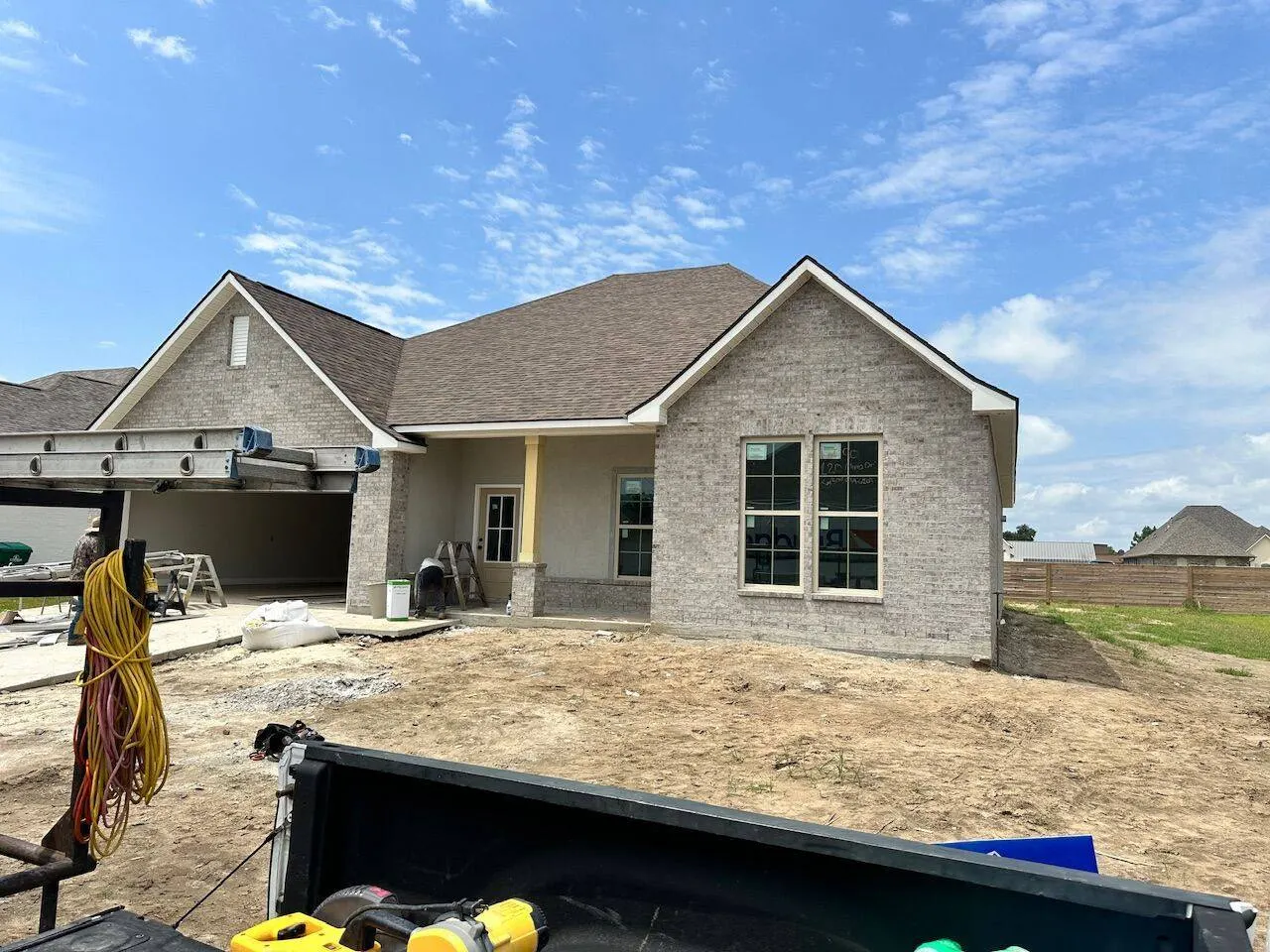 New construction brick home with completed shingle roof in Louisiana