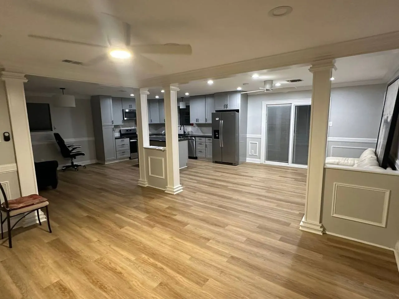 Open concept living room renovation with LVP flooring and kitchen remodel in Metairie LA