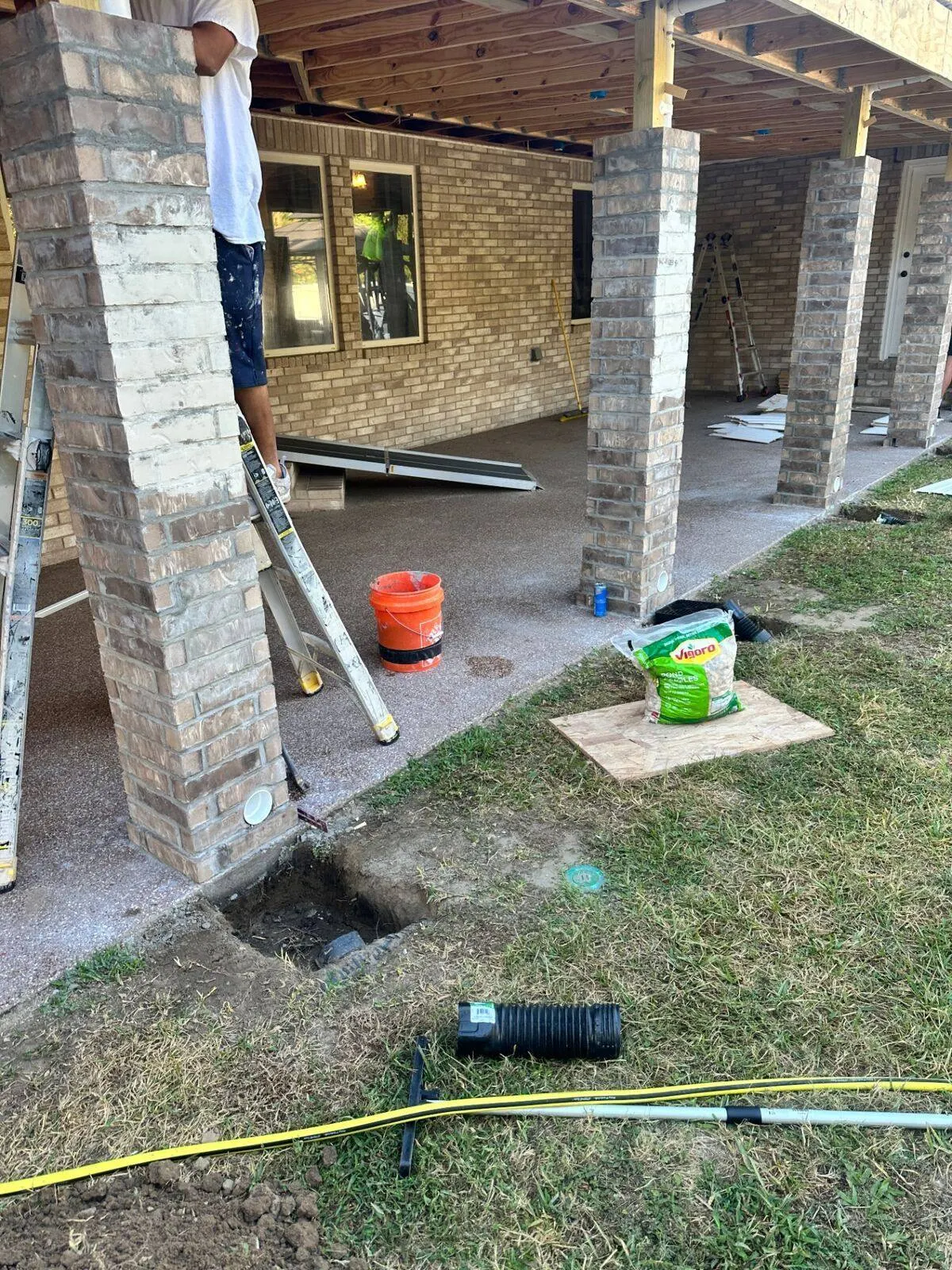 Brick column construction and drainage work during patio addition in River Ridge Louisiana