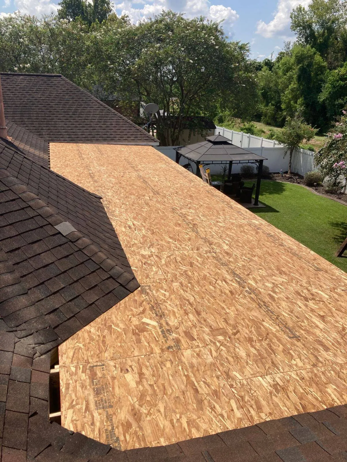 New OSB roof deck sheathing installed on home addition ready for shingles