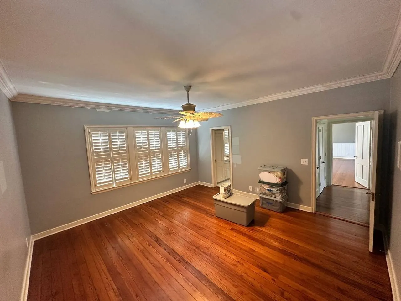 Primary bedroom renovation with hardwood floors and plantation shutters in Covington LA