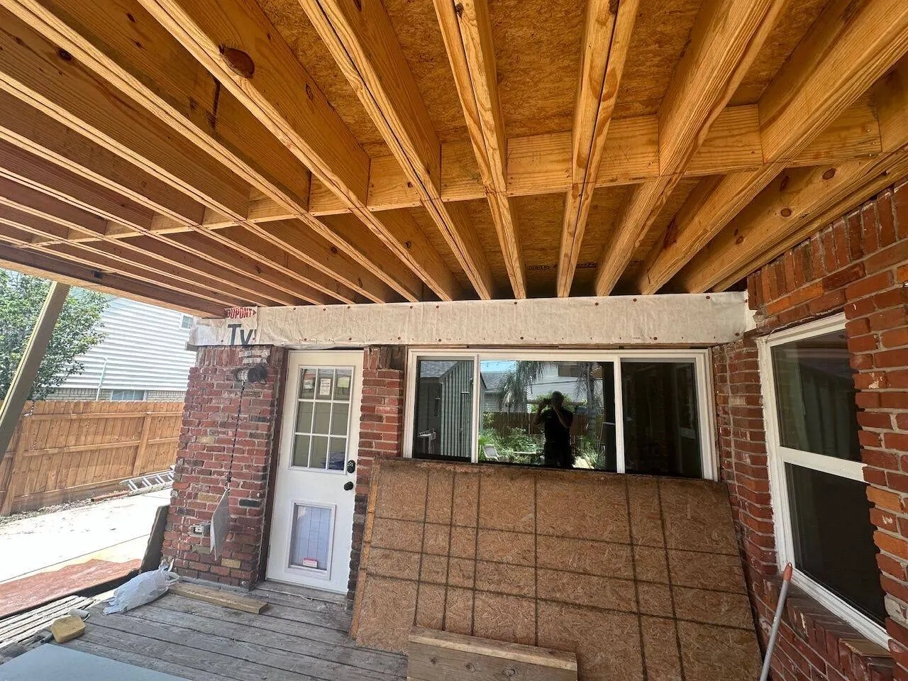 Floor joist and rafter framing underside view at brick home addition in Metairie