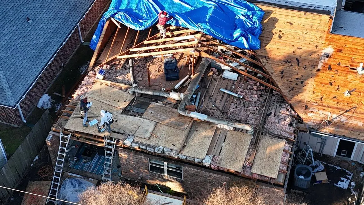 Roofing crew performing roof demo for home addition in Metairie