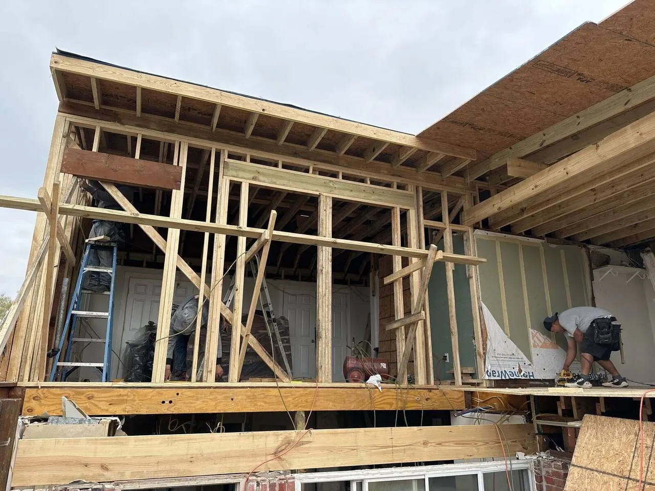 Cajun Home Services crew installing new roof framing on storm-damaged home in Jefferson Parish
