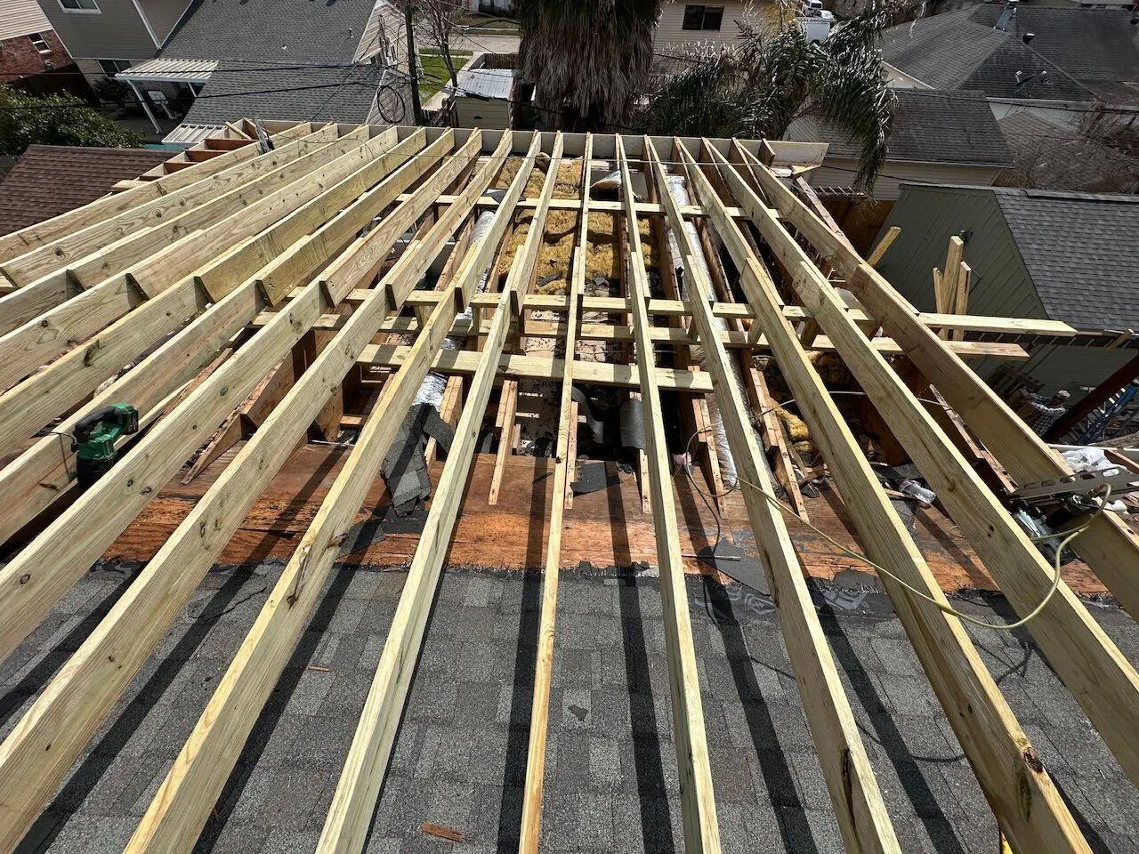 New roof rafter framing during complete roof rebuild by licensed contractor