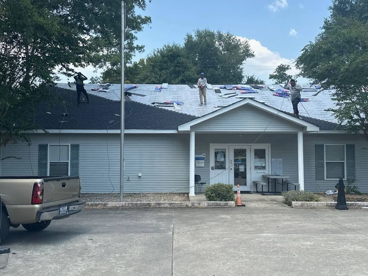 Cajun Home Services crew installing architectural asphalt shingles on residential home in Metairie Louisiana