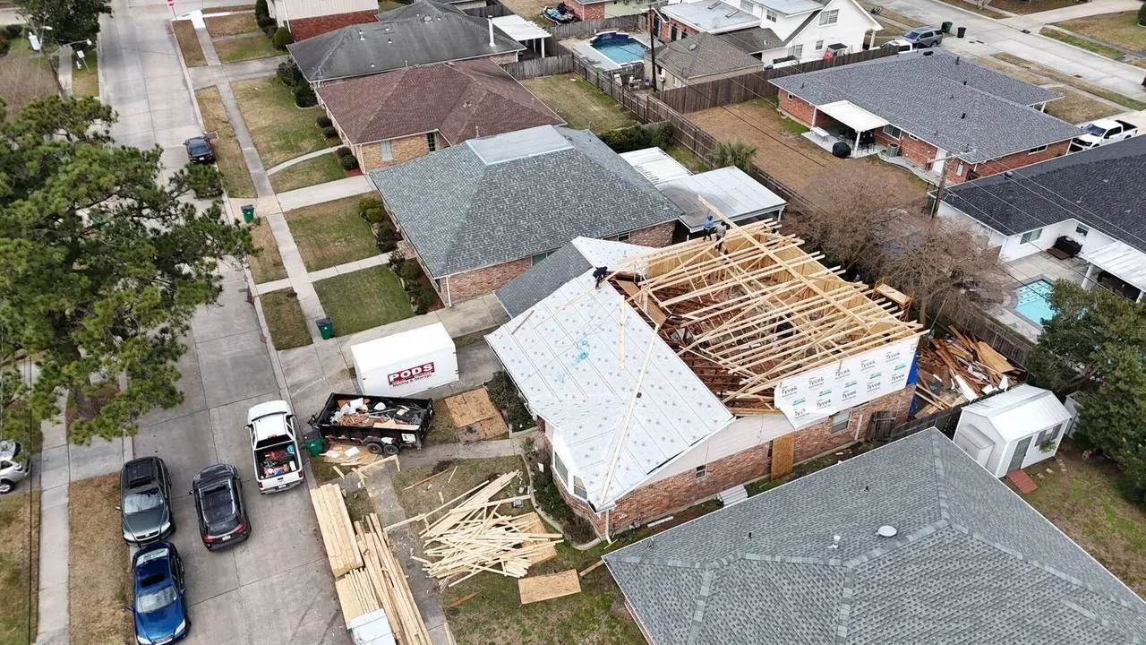 Aerial view of second floor addition wrapped in Tyvek before siding install