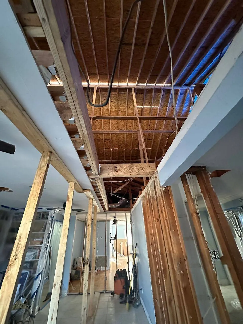 Interior view of second floor framing with floor joists visible in Metairie addition