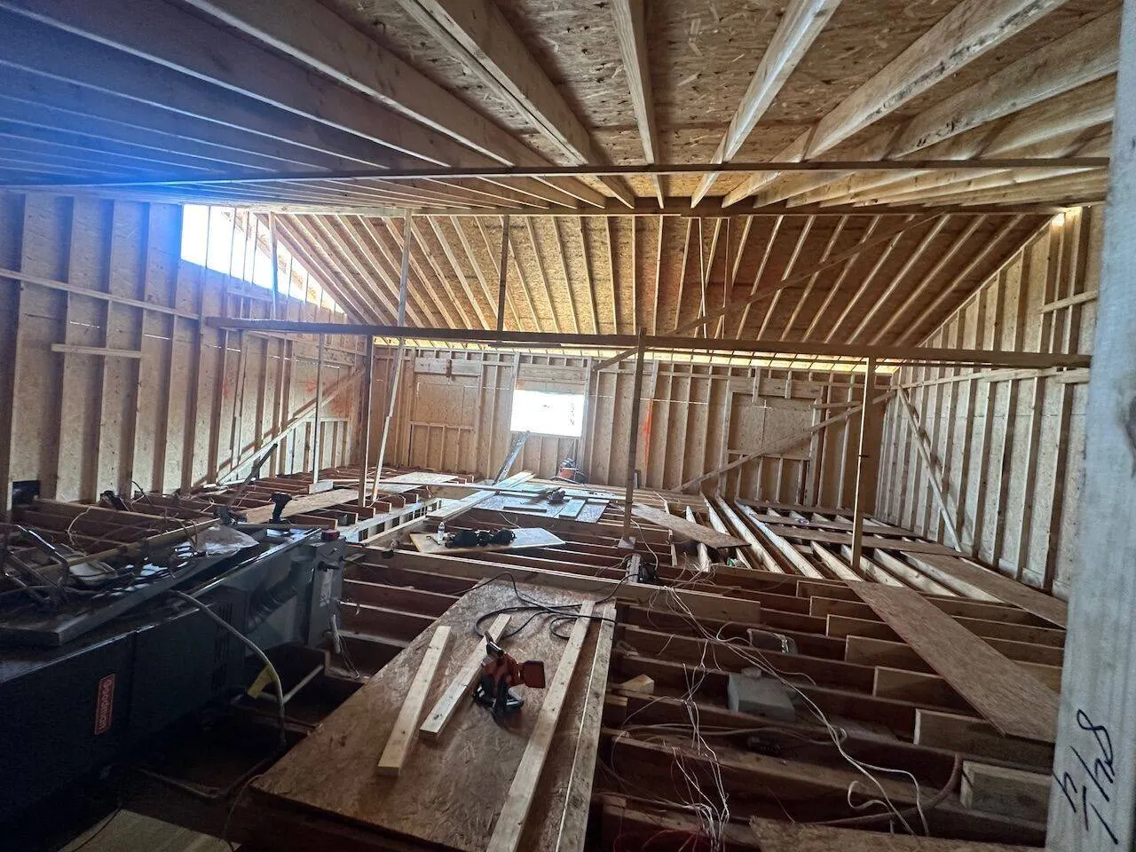 Steel beam with floor joist framing and electrical rough-in during addition in Metairie