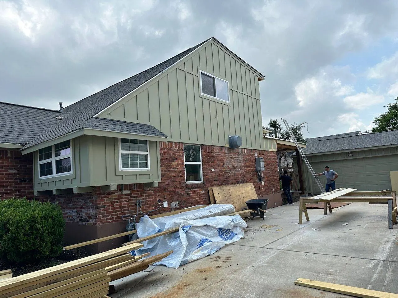 Completed second story home addition with board and batten siding and new roofing in Metairie